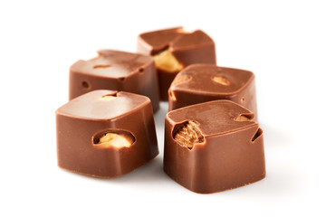 Assortment of chocolate candies sweets isolated on a white background. Chocolate candies collection. Milk chocolate with nuts.