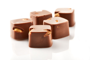 Assortment of chocolate candies sweets isolated on a white background. Chocolate candies collection. Milk chocolate with nuts.