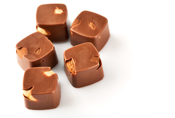 Assortment of chocolate candies sweets isolated on a white background. Chocolate candies collection. Milk chocolate with nuts.