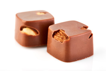 Assortment of chocolate candies sweets isolated on a white background. Chocolate candies collection. Milk chocolate with nuts.