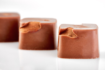 Assortment of chocolate candies sweets isolated on a white background. Chocolate candies collection. Milk chocolate with nuts.