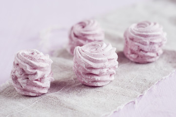 berry marshmallow on a gray napkin over pink background.