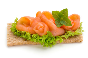 Bread with fresh salmon fillet isolated on white background, top view.