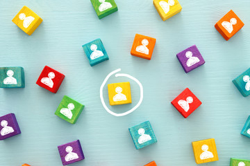 image of colorful blocks with people icons over wooden table ,human resources and management...