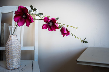 Violet orchid flowers in white vase on wood table vintage antique design