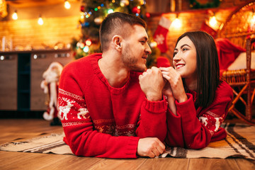 Love couple lies on the floor, christmas holidays