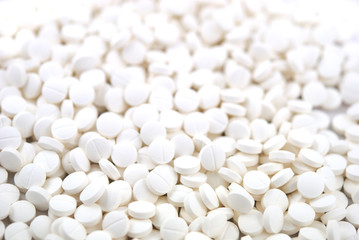 White round tablets close-up background