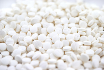 White round tablets close-up background