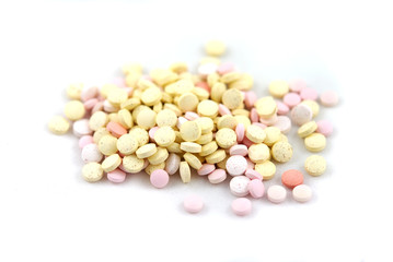 Multicolored round tablets on white background