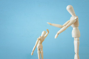 family violence cincept. wooden dummies as parents and child arguing and shouting.