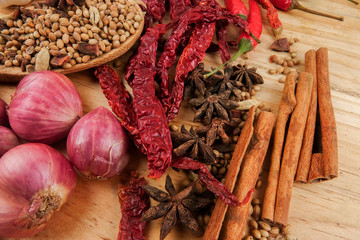 Mixture of beautiful spices and herbs on a wooden table