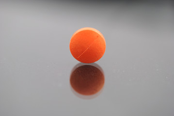 Alone round tablet with reflection closeup isolated