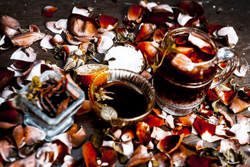 Popular Indian/Asian summer drink i.e NAM MANGLAK or Sweet basil drink consisting of rose syrup,sweet basil and honey with sugar on a wooden surface in Gothic colors.