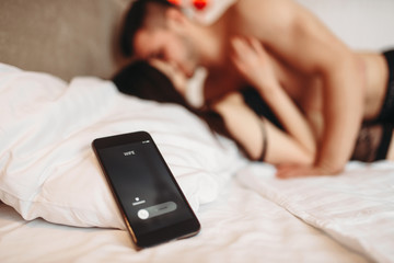 Lovers on big white bed, adultery concept - obrazy, fototapety, plakaty
