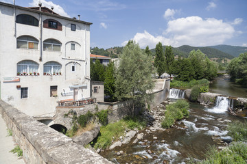 Fototapeta na wymiar Village view, bridge and Freser river in catalan village of Campdevanol, province Girona, Catalonia.Spain.