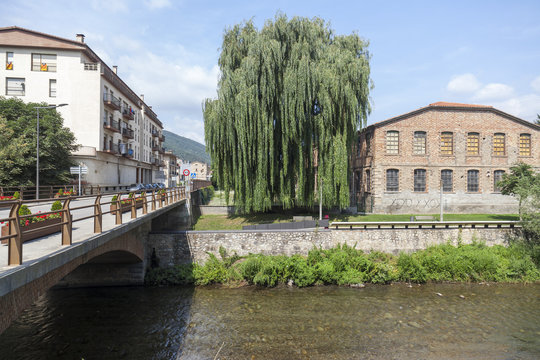 Village view, bridge and Freser river in catalan village of Campdevanol, province Girona, Catalonia.Spain.