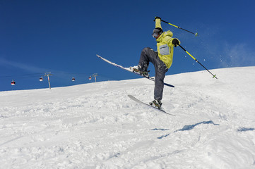 Fototapeta na wymiar Amazing jump of skier on the mountain slope in Gudauri, Georgia