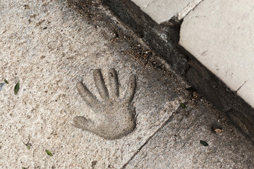 Handprint on the concrete pavement.