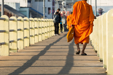 Monk walking in the morning on the bridge, Closeup Foots, Movement images