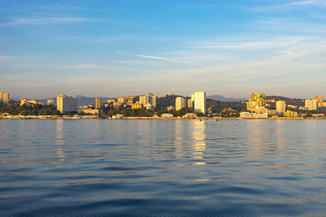 Sea view of the city skyline with modern buildings.