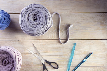 Fototapeta na wymiar Knitting wool and knitting tools on wooden background.