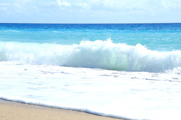 Naklejka na ściany i meble Sea waves on the beach