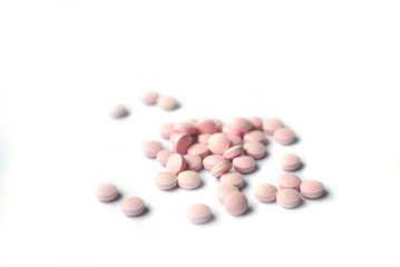 Rose round tablets closeup on white background