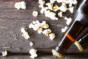 Beer and popcorn on a wooden table