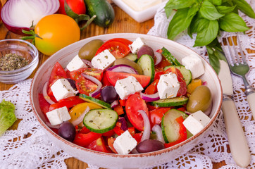 Greek salad with fresh vegetables, feta cheese and olives