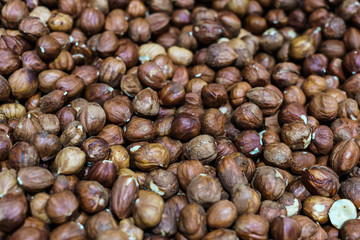 A whole box of peeled brown hazelnut nuts.