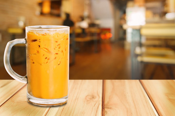 Milk ice tea on wood table.