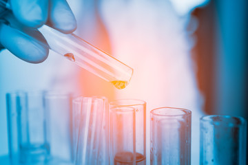 Dropping chemical liquid to test tube, laboratory research and development concept. scientist sample chemistry or medicine test
