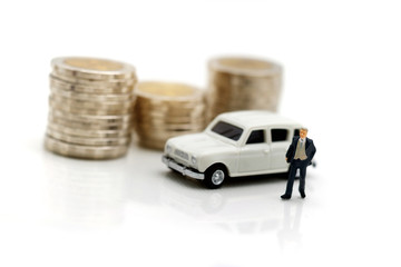 Miniature people: Businessman standing with step of coin money and car.  Concept of Financial and money.
