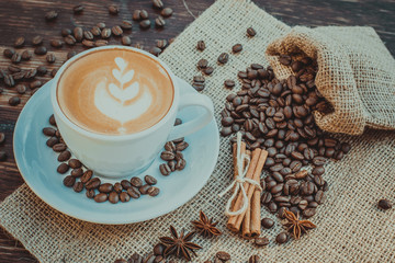 A cup of latte coffee and coffee beans. Toning.