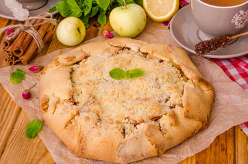 Open pie or galette with apples with cinnamon and crumbs