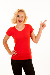 Attractive beautiful young blonde woman pointing into copyspace when advertising a product