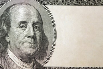 Dollars closeup. Benjamin Franklin's portrait on one hundred dollar bill with copy space