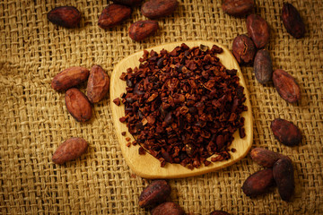Cacao nibs and cocoa beans on burlap