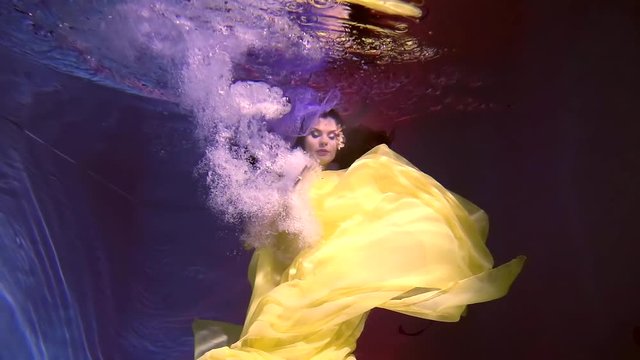 Lovely woman swimming underwater