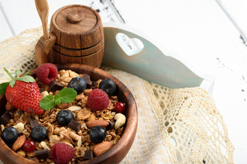 Granola with natural yogurt, fresh blueberries, nuts and honey, delicious breakfast or dessert.Healthy eating concept.