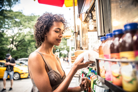 Woman buys hotdog in New York