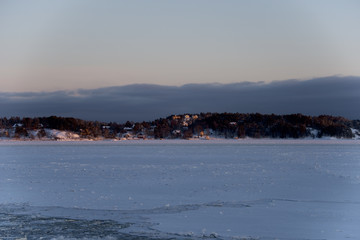 Winter evening on the ferry from Stockholm city to Vaxholm in Stockholm archipelago a snowy, icy and cold day