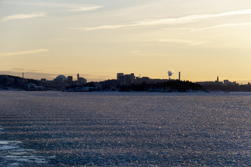 Fototapeta premium Winter evening on the ferry from Stockholm city to Vaxholm in Stockholm archipelago a snowy, icy and cold day