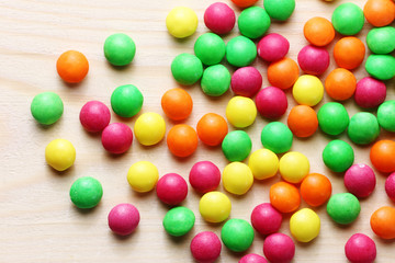 Colorful sweet candies on a wood background