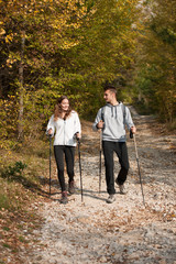 Young couple hikino on a warm autumn afternoon in nature