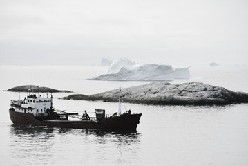 black and white - lonely fishing boat in the disko bay - Greenland Ilulissat - ocean with icebergs - nautical vessel, marina