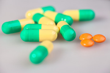 pills, capsules, on a white matte background, close-up.