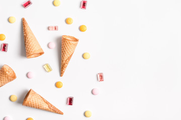 Ice cream cones and candy flat lay image with copy space.