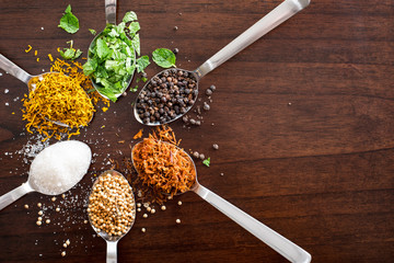 herbs and spices on wooden table top  -shot from above