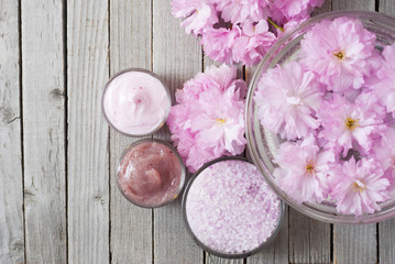 Fototapeta na wymiar Cosmetic creams with japanese cherry flowers